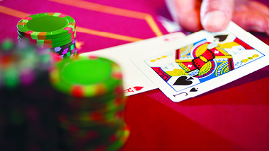Blackjack cards on red table with gaming chips