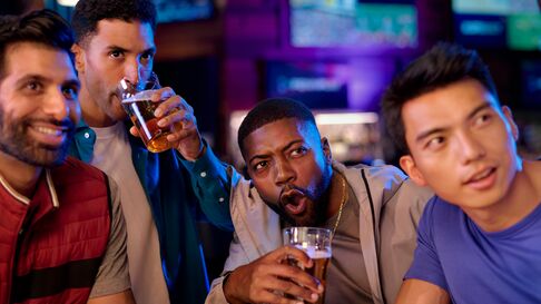 Four People Drinking watching sports 